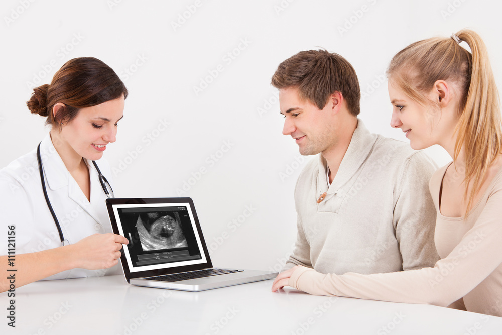 Doctor Showing Ultrasound Scan Of Baby On Digital Tablet Doctor Showing Ultrasound Scan Of Baby On Digital Tablet