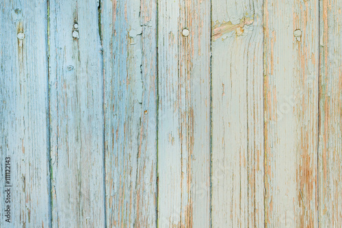 Abstract background - Old wooden planks with cracked light blue paint in daylight
