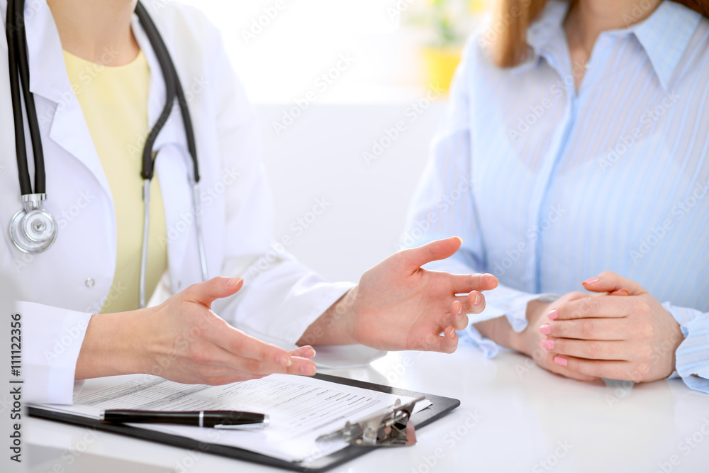 Doctor and patient are discussing something, just hands at the table Doctor and patient are discussing something, just hands at the table