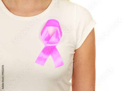 Closeup pink cancer ribbon on woman chest