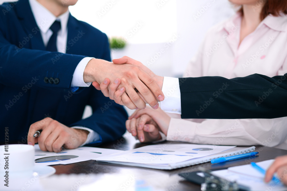 Business people shaking hands finishing up a meeting Business people shaking hands finishing up a meeting