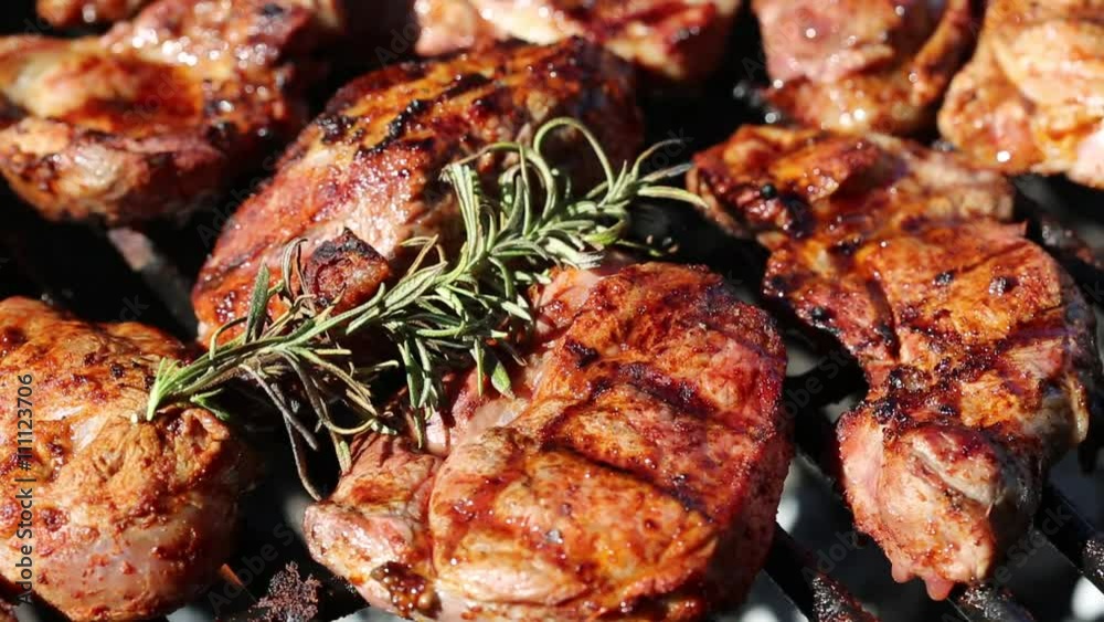 Fresh lamb meat with rosemary on the grill Fresh lamb meat with rosemary on the grill