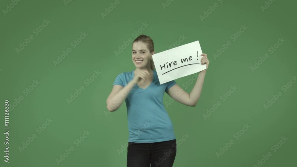 attractive caucasian casual girl isolated on green with hire me sign