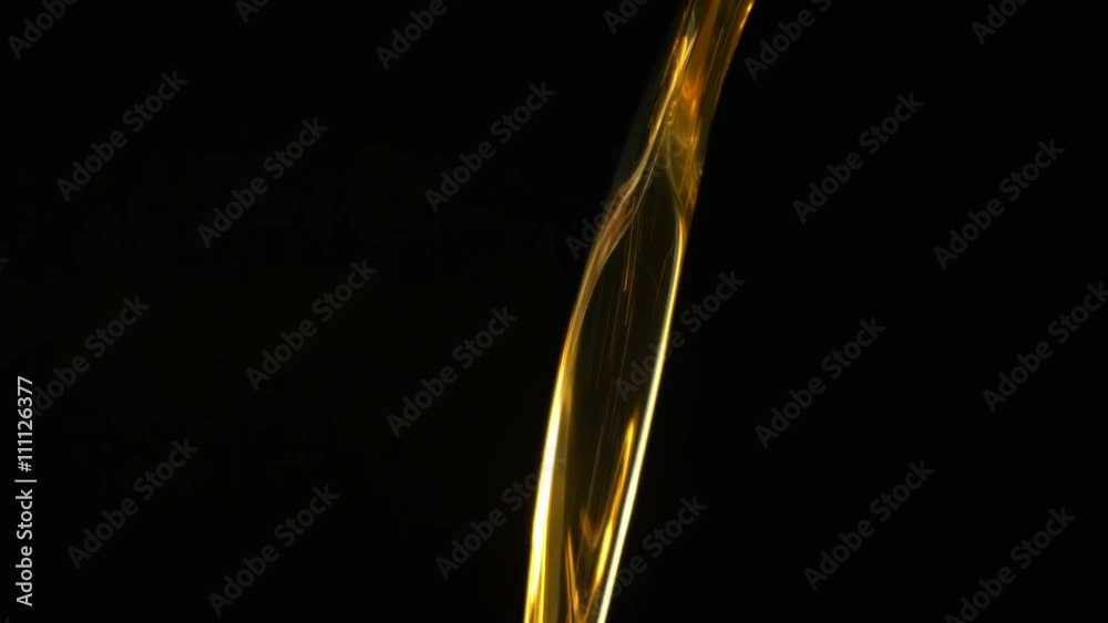 Motor oil pouring on black background.
Motor oil pouring on black background.
