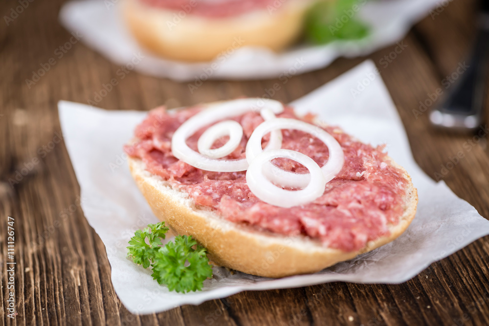 Mett on a bun (German cuisine; selective focus) Mett on a bun (German cuisine; selective focus)