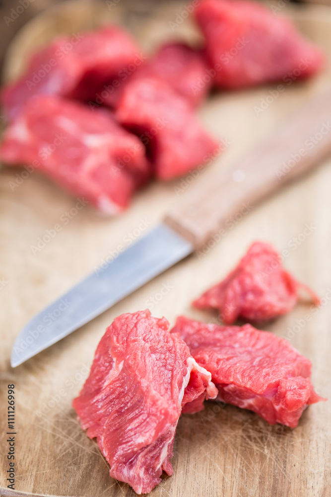 Beef Fillet (chopped) on wooden background