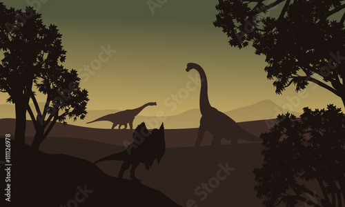 Dilophosaurus and Brachiosaurus silhouette in hills