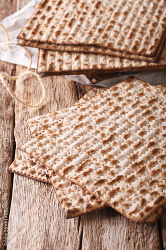 traditional Jewish kosher matzo for Passover macro on a table. Vertical
