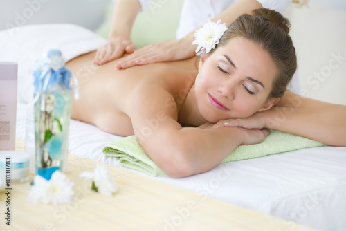Beautiful young woman relaxing in the spa salon