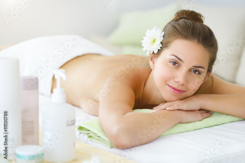 Beautiful young woman relaxing in the spa salon