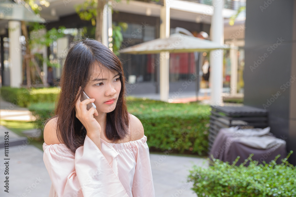 Beautiful young brunette woman calling by phone in the shop