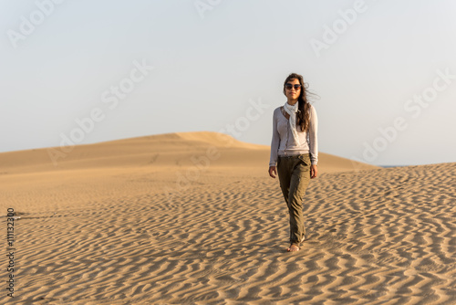 Girl walking on sand dunes in Gran Canaria, Spain