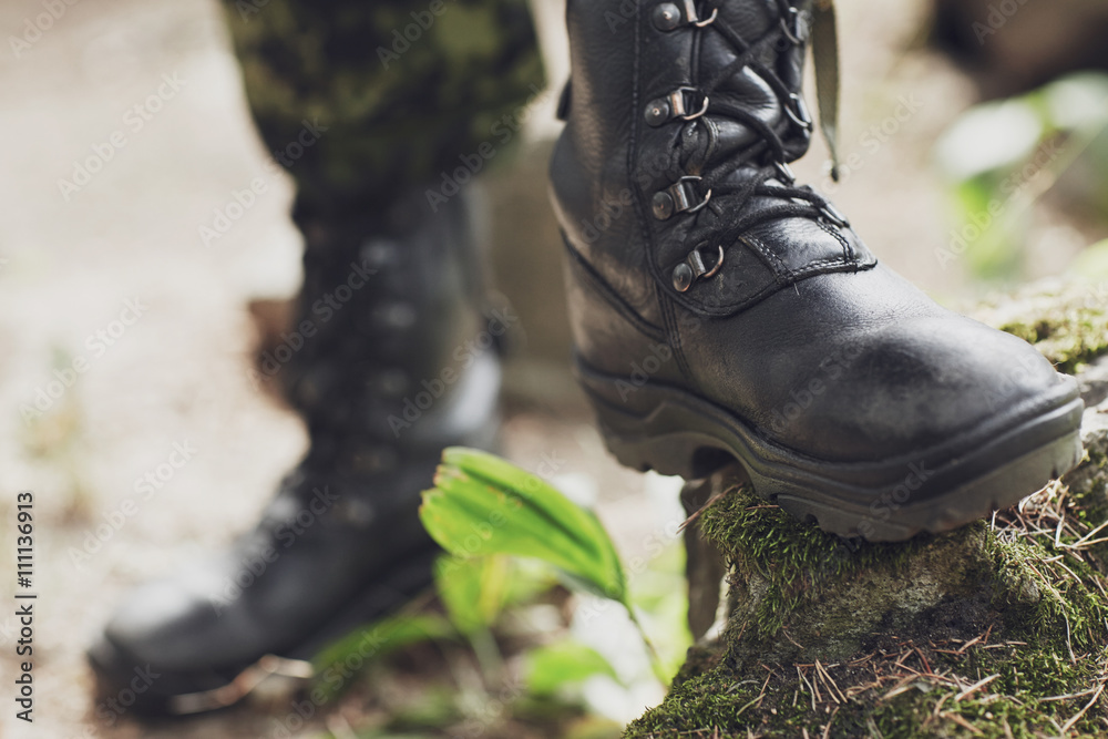 close up of soldier feet with army boots in forest close up of soldier feet with army boots in forest