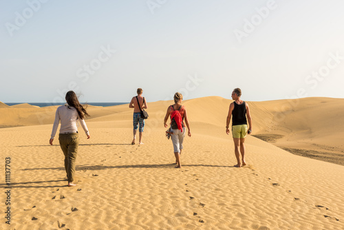 People walking through the desert