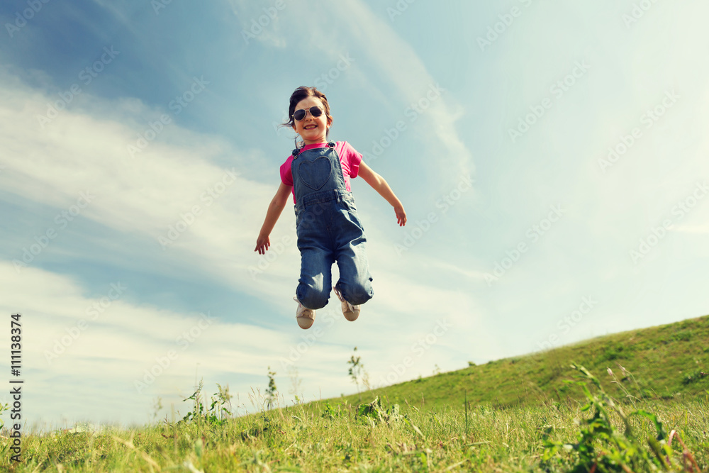happy little girl jumping high outdoors happy little girl jumping high outdoors