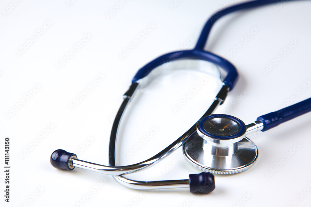 Silver stethoscope lying down on an laptop, toned blue Silver stethoscope lying down on an laptop, toned blue