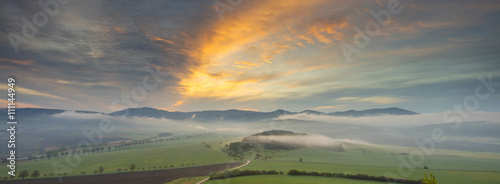 sunset lights in the sky and fog in valley 