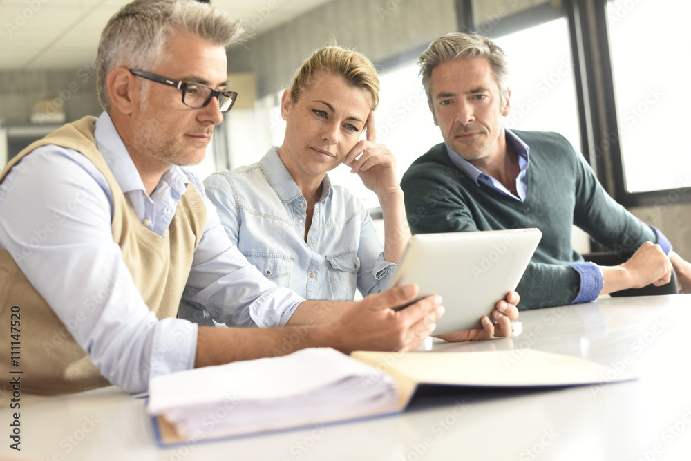 Business people in a meeting using tablet Business people in a meeting using tablet
