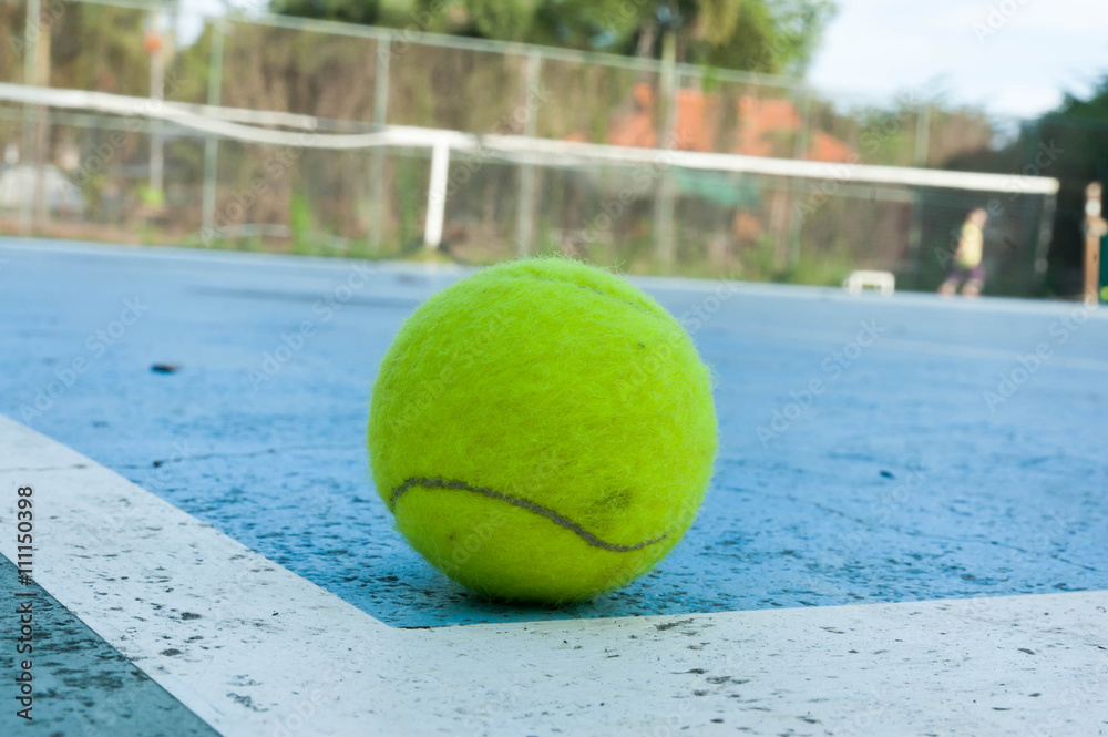 tennis ball on hard court background