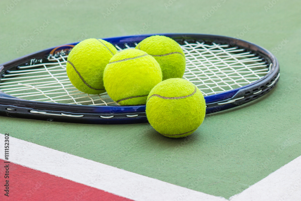 Tennis Ball with Racket on the clay tennis court