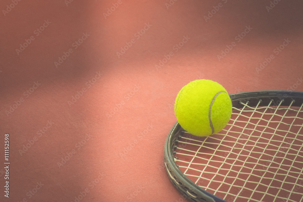 Tennis Ball with Racket on the clay tennis court. vintage