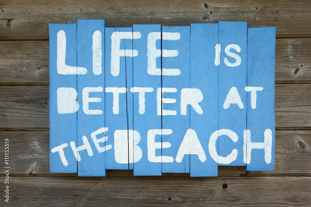 Fototapeta premium sign/ self made sign saying that life is better at the beach