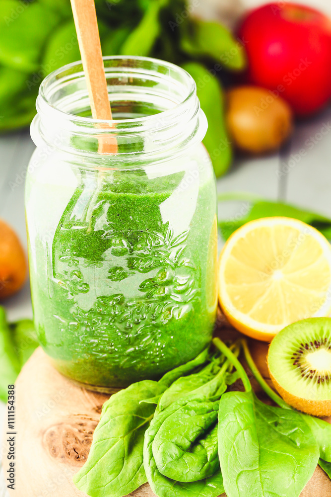 green detox smoothie with spinach in a jar, kiwi and citrus green detox smoothie with spinach in a jar, kiwi and citrus