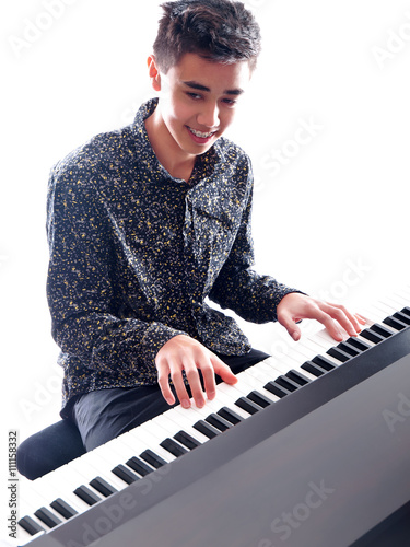 teenage boy playing piano