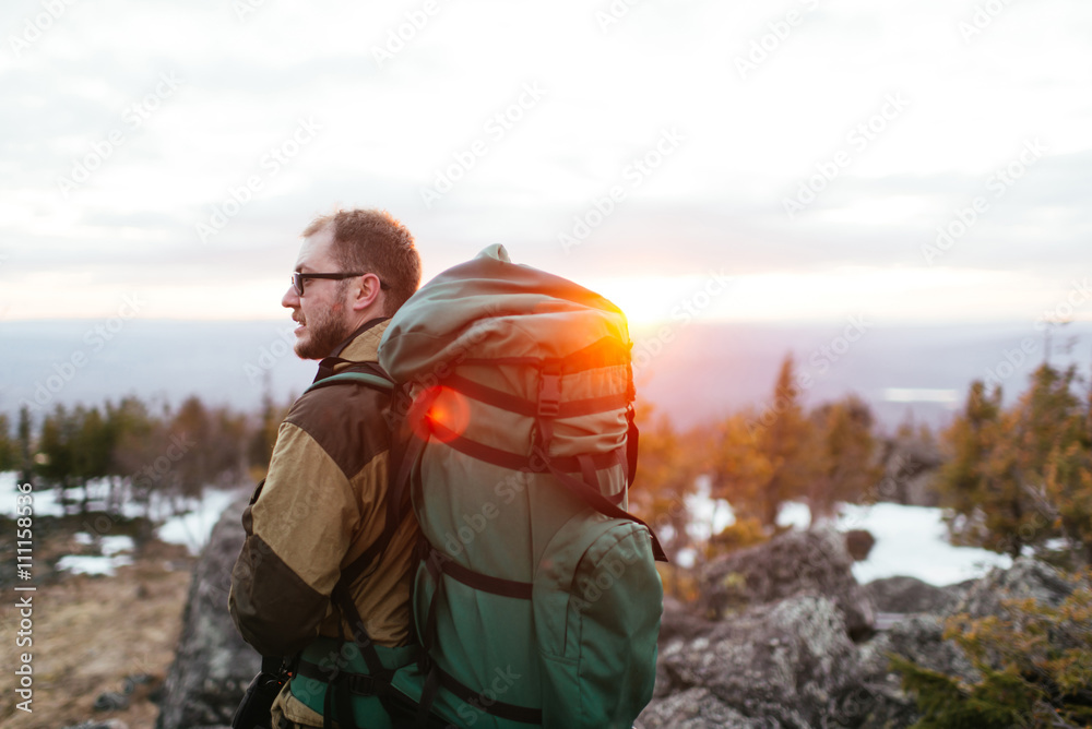 Naklejka premium tourist with a backpack in the mountains, snow