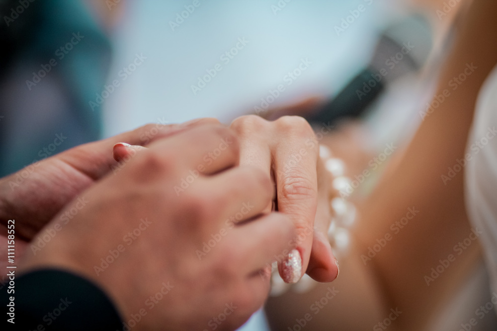 The bride and groom exchange rings, wedding ceremony, hands closeup