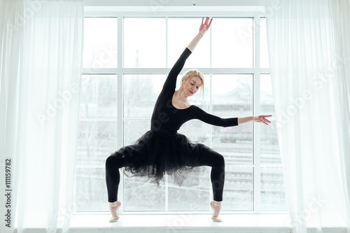  ballerina in black tutu over white window