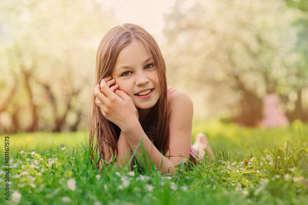 summer outdoor close up portrait of beautiful happy kid girl lying on the grass in park summer outdoor close up portrait of beautiful happy kid girl lying on the grass in park