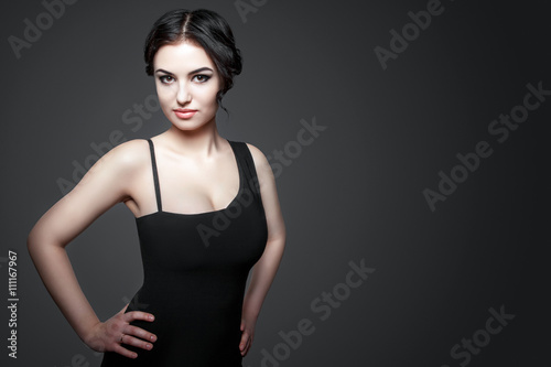 Portrait of beautiful female model on gray background