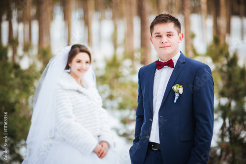 Happy bride and groom in winter day on their wedding © deineka