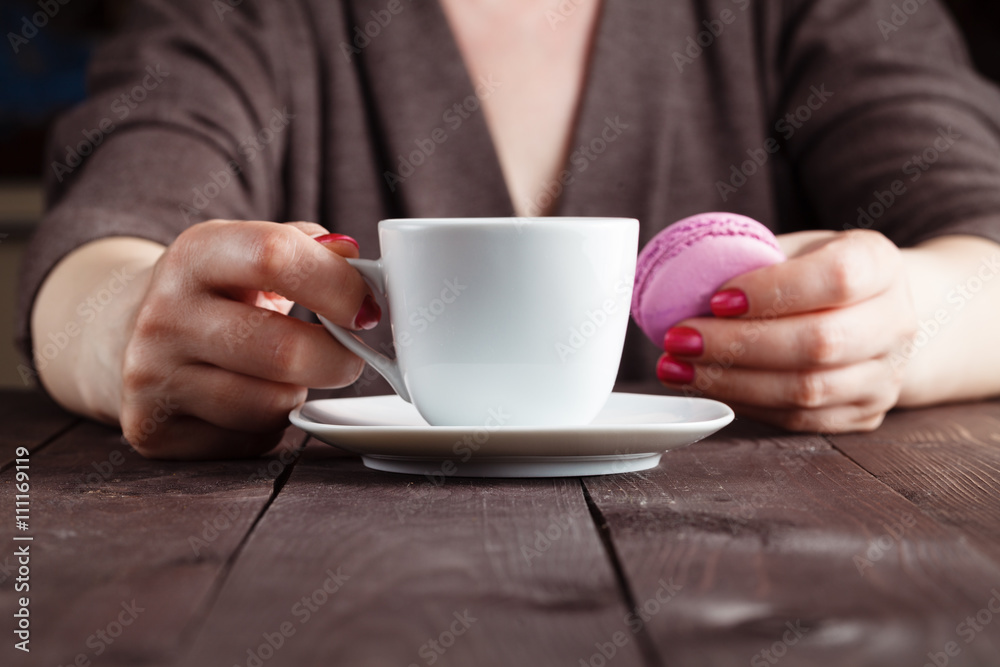 Coffee and macaron cookies on table in the morning Coffee and macaron cookies on table in the morning