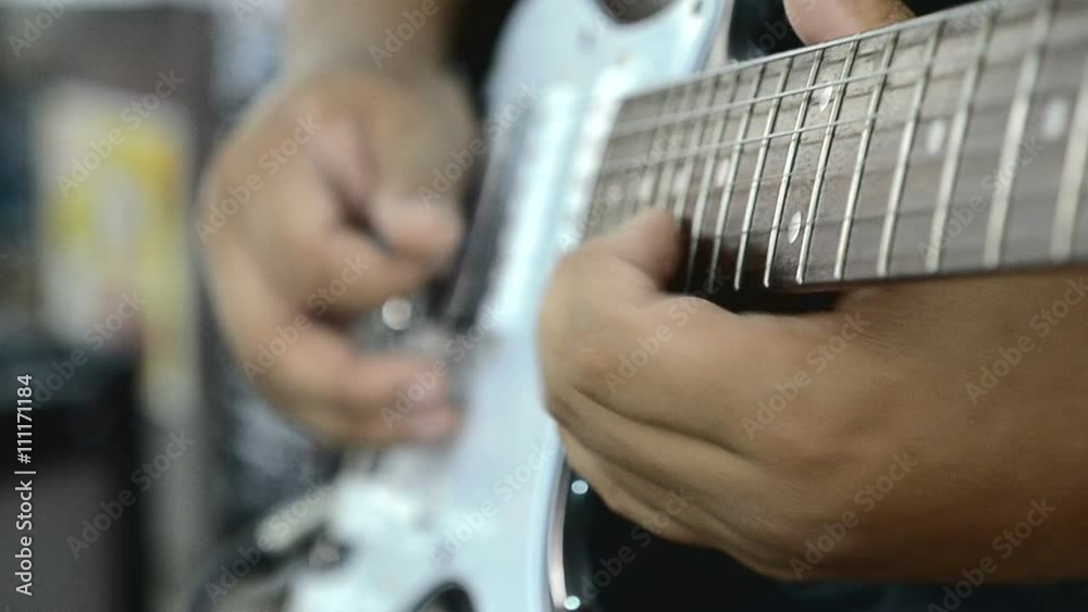 Close up hands playing electric guitar solo with speed picking technic 