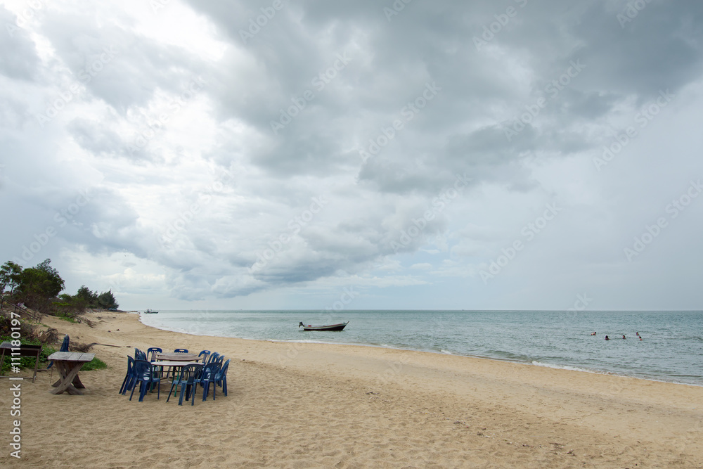 Cloudy sky on the beach with barbecue table and chair