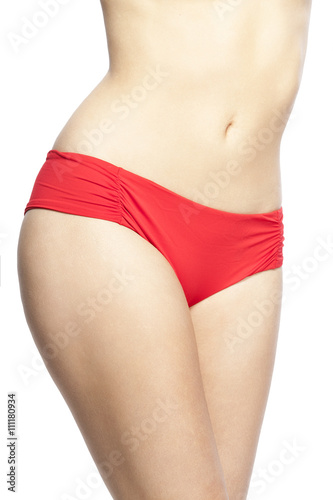 Detail of fit young woman in red bikini. Isolated on white background. Summer concept