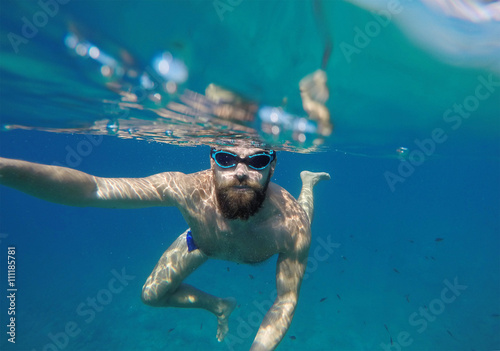 Man doing underwater selfie shot with selfie stick