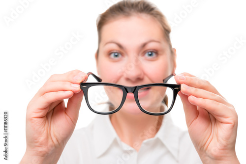 woman with poor eyesight wears glasses, focus on glasses