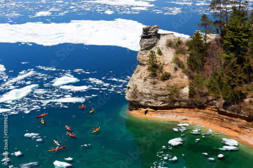 Kayaks at Miners Castle on Lake Superior. Late ice breakup created unusual ice formations at Pictured Rocks National Lakeshore in the Upper Peninsula of Michigan