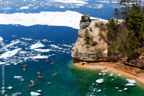 Kayaks at Miners Castle on Lake Superior. Late ice breakup created unusual ice formations at Pictured Rocks National Lakeshore in the Upper Peninsula of Michigan photo