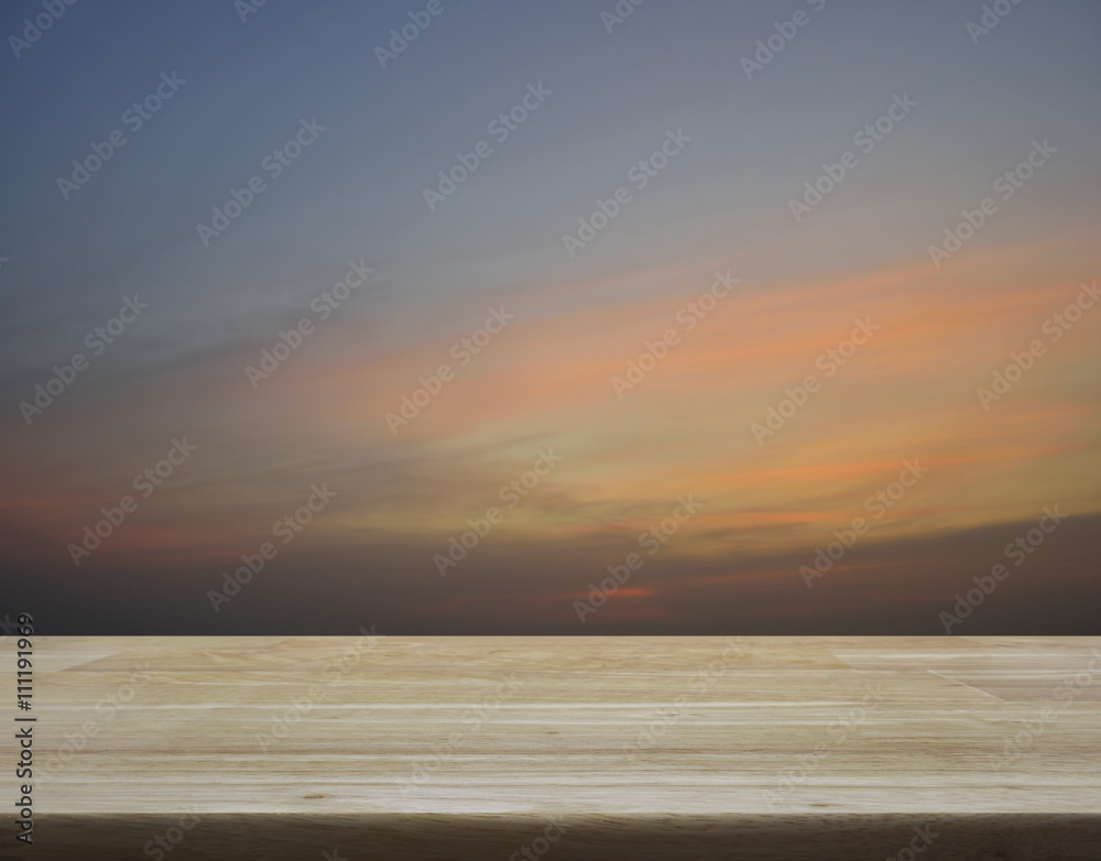 Empty wooden table with sunset sky with clouds for background, f