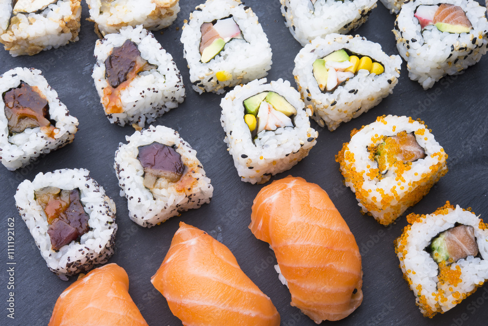 Sushi rolls on a slate plate Sushi rolls on a slate plate