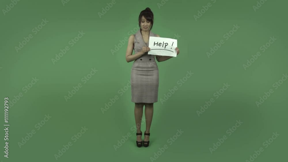indian business woman isolated on green with help sign indian business woman isolated on green with help sign
