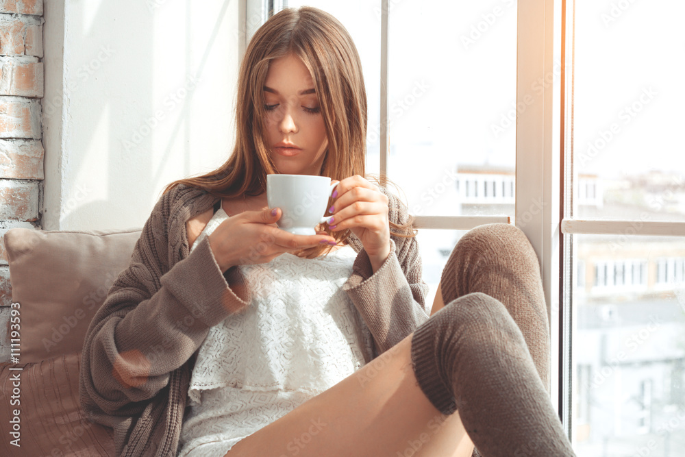 Beautiful Young Woman Sitting On A Windowsill Beautiful Young Woman Sitting On A Windowsill