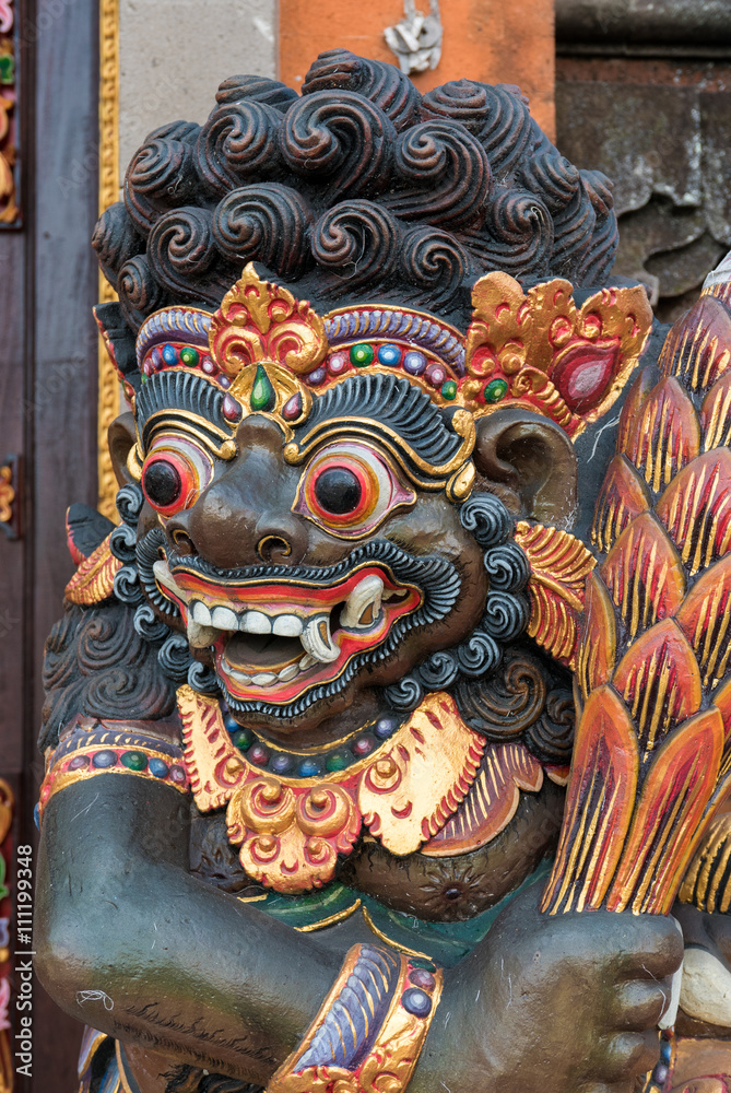 Dragon wooden sculpture on temple door in Bali, Indonesia