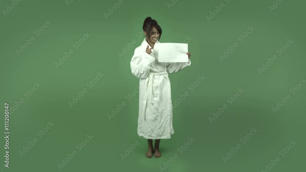 indian woman in bathrobe isolated on green happy with blank sign indian woman in bathrobe isolated on green happy with blank sign
