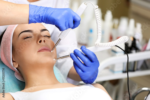 Young woman having face pro...