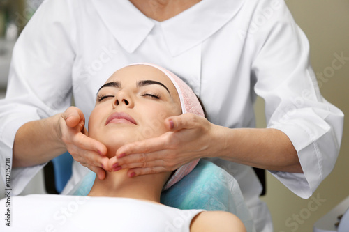 Young woman having face mas...
